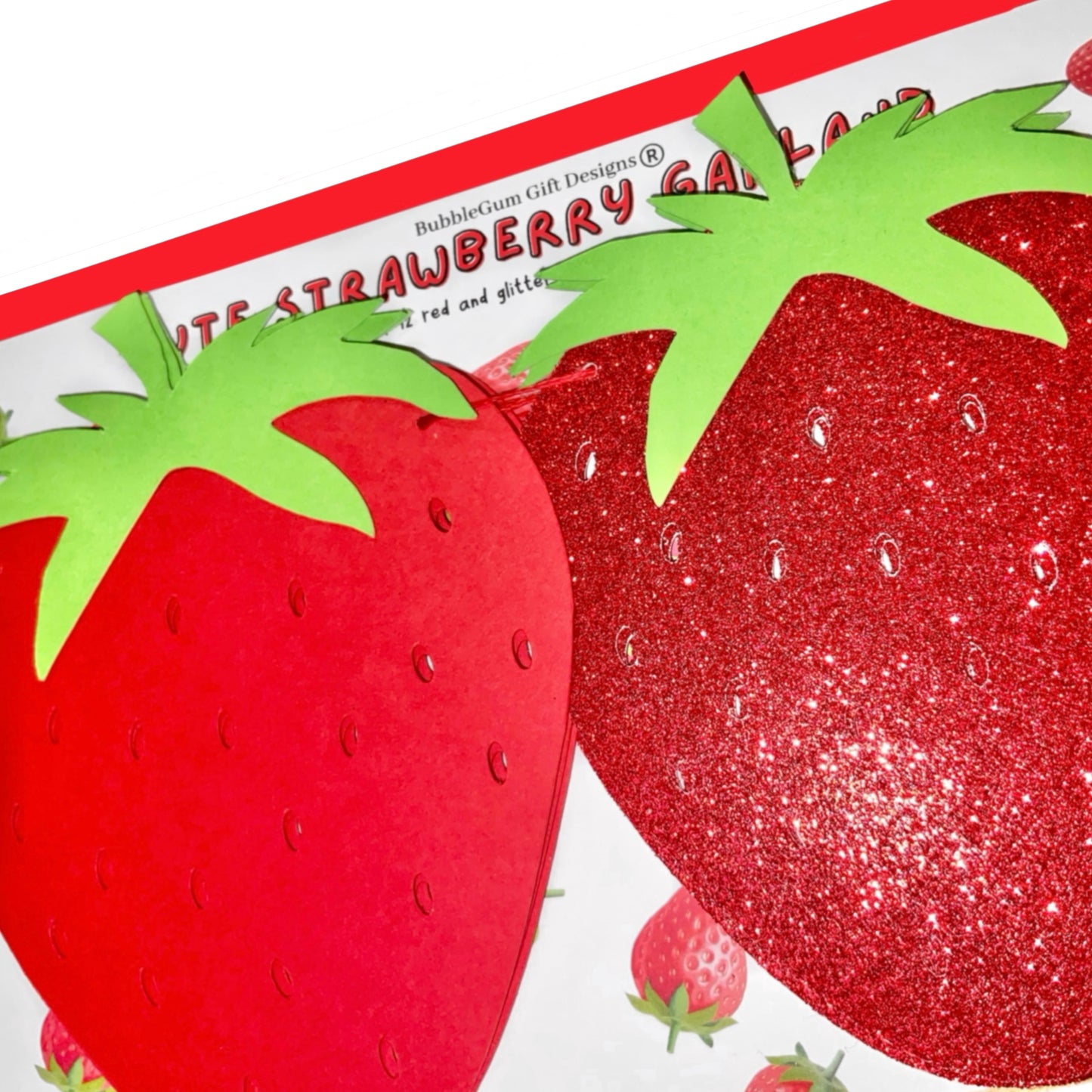 Close-up of cute red and red glitter strawberries on strawberry garland