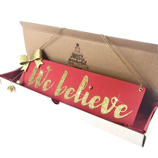 We believe sign Christmas decoration, Traditional red and gold Christmas wall hanging for those who believe in Santa